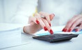 Close up hand of female accountant or banker making calculations. Savings, finances and economy concept Royalty Free Stock Photo