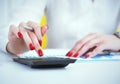 Close up hand of female accountant or banker making calculations. Savings, finances and economy concept Royalty Free Stock Photo