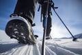 Close up on a female adventurer's boot, ski and binding during ski touring in the mountains