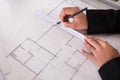 Close-up of female architect drawing blueprint Royalty Free Stock Photo