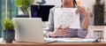 Close Up Of Female Architect In Office Sitting At Desk Showing Plans For New Building On Video Call Royalty Free Stock Photo