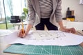 Close Up Of Female Architect Standing Working In Office Studying Plans For New Building Royalty Free Stock Photo