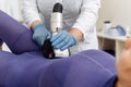 Close up of female back and buttocks, in purple LPG slimming bodysuit, getting lpg integral massage, which is carried out by the Royalty Free Stock Photo