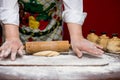 Close up of female baker hands kneading dough and making bread with a rolling pin Royalty Free Stock Photo