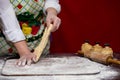 Close up of female baker hands kneading dough and making bread with a rolling pin Royalty Free Stock Photo