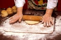 Close up of female baker hands kneading dough and making bread with rolling pin Royalty Free Stock Photo