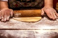 Close up of female baker hands kneading dough and making bread with rolling pin Royalty Free Stock Photo