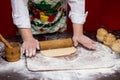 Close up of female baker hands kneading dough and making bread with a rolling pin Royalty Free Stock Photo