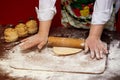 Close up of female baker hands kneading dough and making bread with a rolling pin Royalty Free Stock Photo