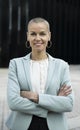 Close up of a female businesswoman with arms folded. Modern style executive looking at camera