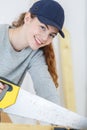 Close-up female carpenter sawing wood Royalty Free Stock Photo