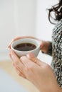 Close up of female hands with a mug of coffee. Royalty Free Stock Photo