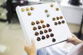 Close up of a female client examining hair color chart at the hairdressing studio coloring dyeing variety changing women hair care