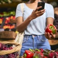 Close Up Of Female Customer At Market Stall Taking Photo Of Fresh Bell Pepper On Mobile Phone