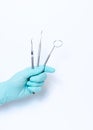 Close-up of female dentist doctor hand holding dental tools. The instruments in dental office Royalty Free Stock Photo