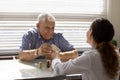 Close up female doctor giving medicine to smiling senior man Royalty Free Stock Photo