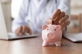 Close up of female doctor hand put money in piggybank