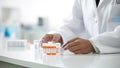 Close up of a female doctor holding a test tube with orange liquid