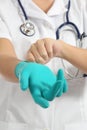 Close up of a female doctor putting latex gloves Royalty Free Stock Photo