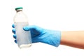 Close up of female doctor's hand in blue sterilized surgical glove holding transparent white glass bottle for medicines with a dru