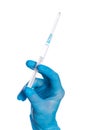 Close up of female doctor`s hand in blue sterilized surgical glove with plastic medical syringe white background Royalty Free Stock Photo