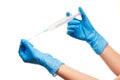 Close up of female doctor's hands in blue sterilized surgical gloves with plastic medical syringe against white Royalty Free Stock Photo