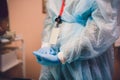 Close up of female doctor`s hands putting on blue sterilized surgical gloves in the office. Royalty Free Stock Photo