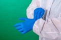 Close up of female doctor`s hands putting on blue sterilized surgical gloves in the office. Royalty Free Stock Photo