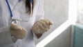 Close up of female doctor`s hands putting on sterilized surgical gloves in the office. Royalty Free Stock Photo