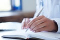 Close up of female doctor`s hands taking notes. Ward round, patient visit check, medical calculation and statistics Royalty Free Stock Photo