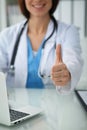 Close up of female doctor thumbs up. Happy cheerful smiling brunette physician ready to examine patient. Medicine Royalty Free Stock Photo