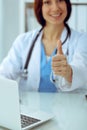 Close up of female doctor thumbs up. Happy cheerful smiling brunette physician ready to examine patient. Medicine Royalty Free Stock Photo