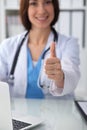 Close up of female doctor thumbs up. Happy cheerful smiling brunette physician ready to examine patient. Medicine Royalty Free Stock Photo
