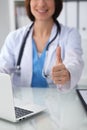 Close up of female doctor thumbs up. Happy cheerful smiling brunette physician ready to examine patient. Medicine Royalty Free Stock Photo