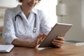 Close up of female doctor use tablet in clinic Royalty Free Stock Photo