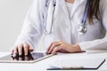 close up female doctor using digital tablet medical report desk. High quality photo Royalty Free Stock Photo