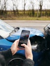 Close Up Of Female Driver Taking Photos Of Road Traffic Accident On Mobile Phone For Insurance Claim Royalty Free Stock Photo