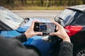 Close Up Of Female Driver Taking Photos Of Road Traffic Accident On Mobile Phone For Insurance Claim Royalty Free Stock Photo