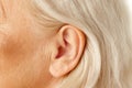 Close-up of female ear. Senior model. Hearing problems and health care, deafness, health check up