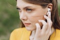 Close up of female ear with wireless earphone inside listening to music. Young beautiful woman with wireless earphones Royalty Free Stock Photo