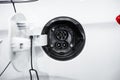 Close-up female electric power plug of white electric car Royalty Free Stock Photo