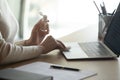 Close up of female employee disinfect workplace with sanitizer