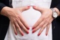 Close-up of female entrepreneur touching abdomen bloated belly