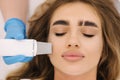 Close up of female face with soft skin. Woman at cosmetology clinic taking a beauty procedure for skin. Beautician using Royalty Free Stock Photo