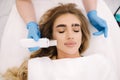 Close up of female face with soft skin. Woman at cosmetology clinic taking a beauty procedure for skin. Beautician using Royalty Free Stock Photo