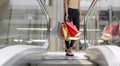 Close up of female feet. Hands hold colored bags for shopping goods. Royalty Free Stock Photo