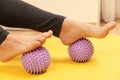 Female feet and purple prickly massage balls