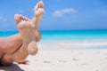 Close up of female feet on white sandy beach Royalty Free Stock Photo