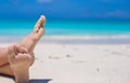 Close up of female feet on white sandy beach Royalty Free Stock Photo