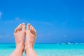 Close up of female feet on white sandy beach Royalty Free Stock Photo